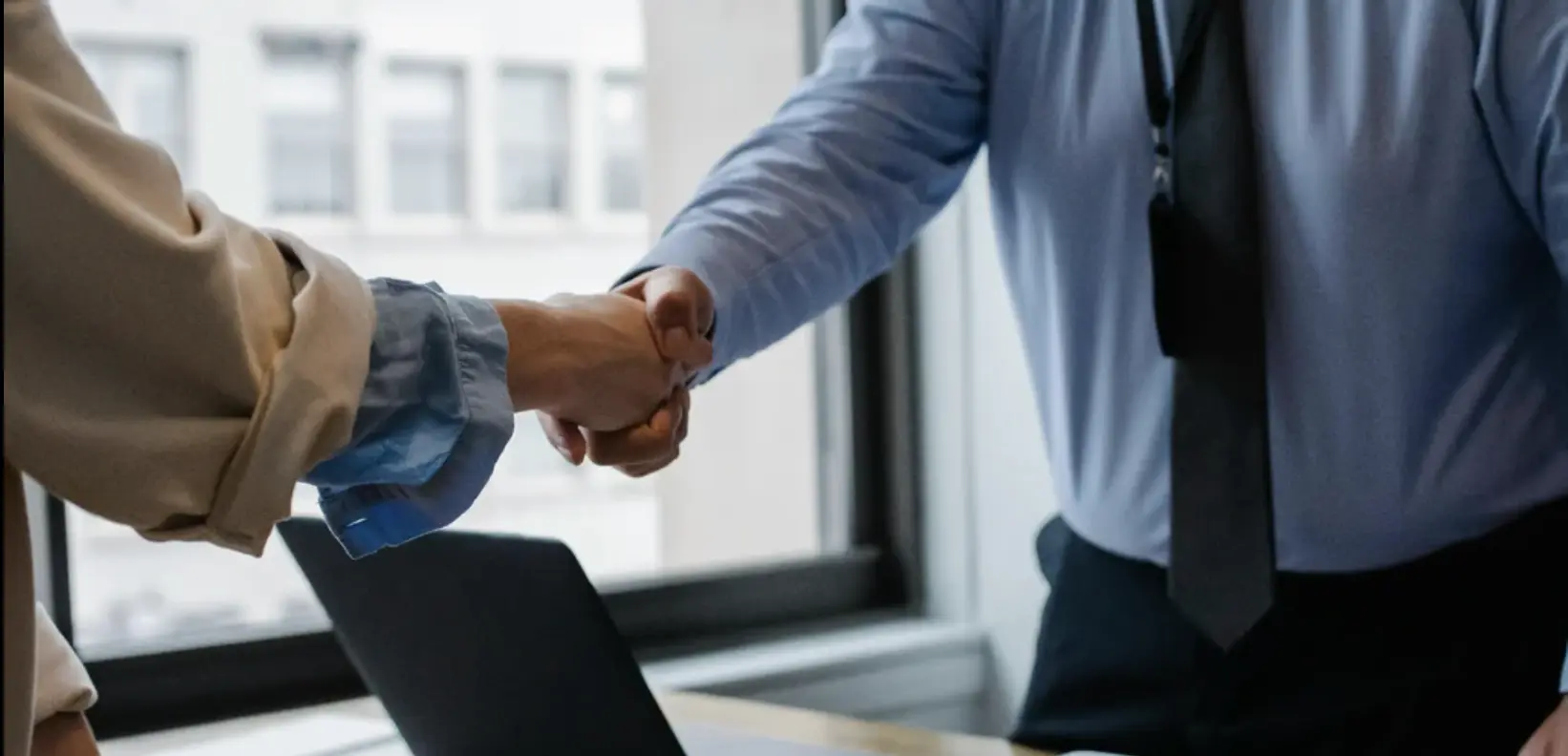 professional handshake during insurance claims consultation