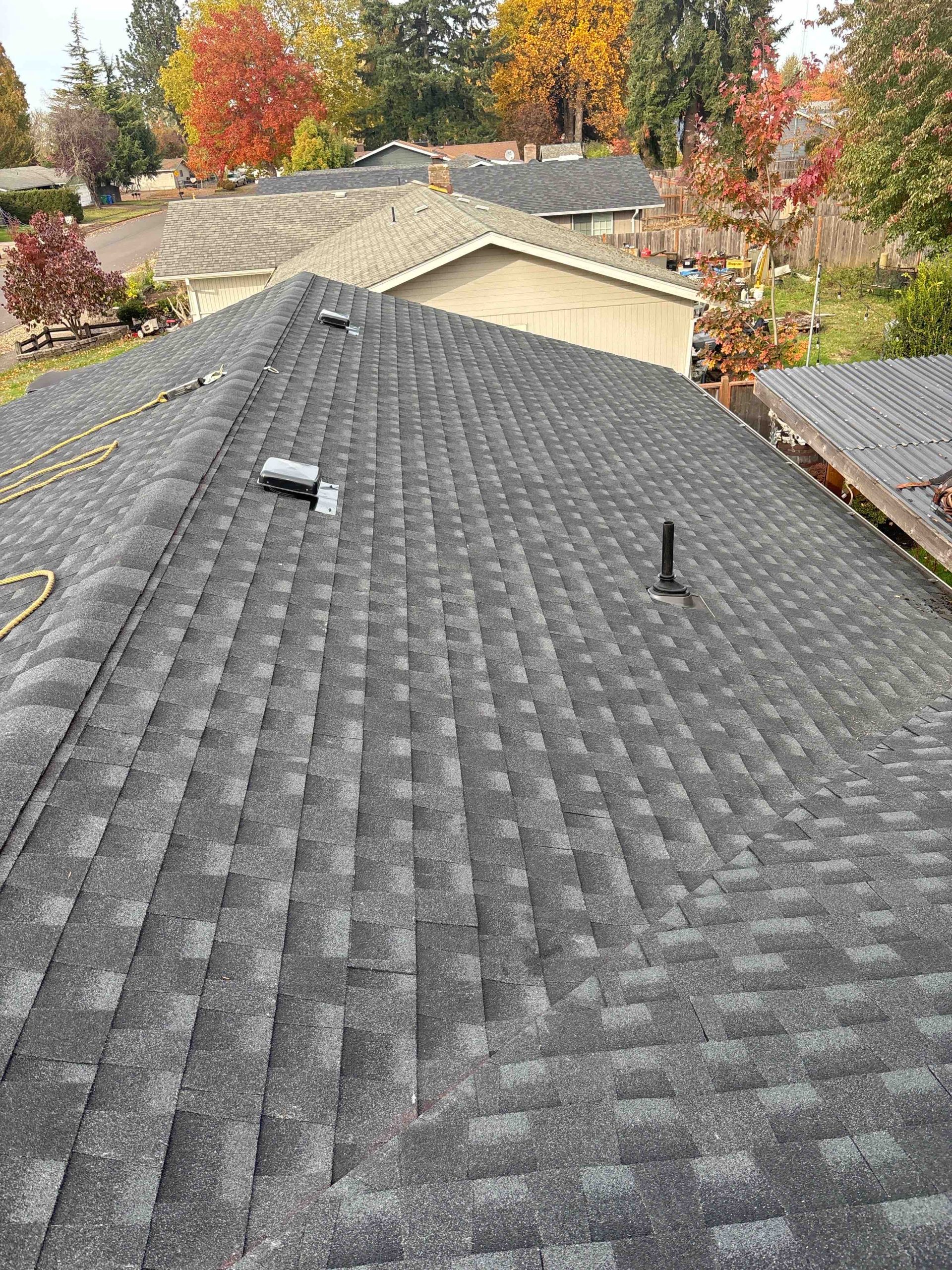 Completed asphalt shingle roof replacement on a residential home